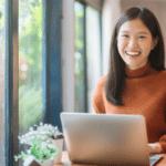 woman smiling in front of laptop