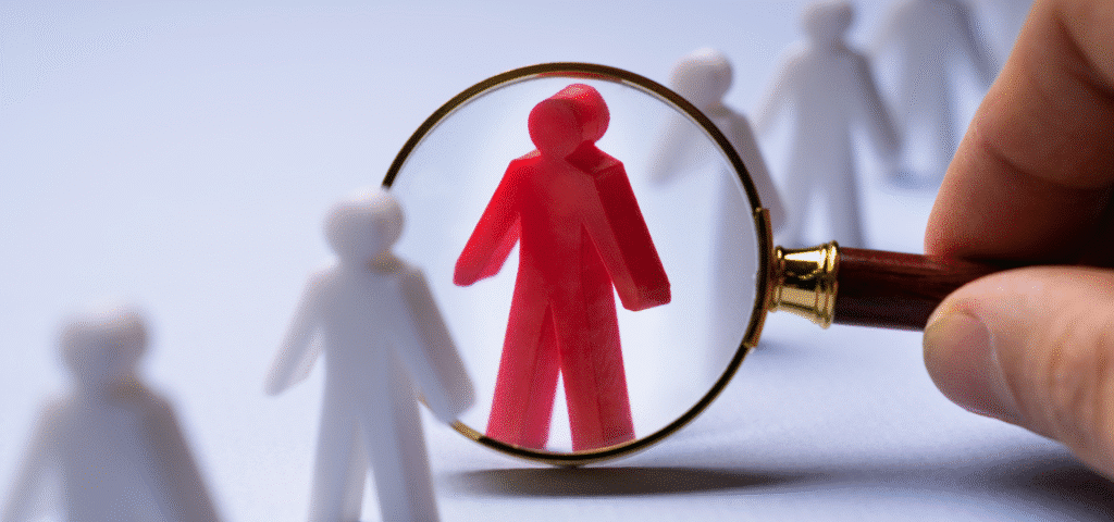 person figure under magnifying glass
